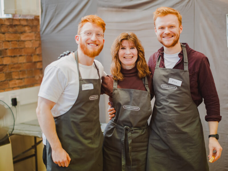 A mum and her two sons enjoying a mothers day candle making workshop